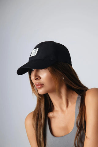 A dynamic shot of the Avery Cap in action, showing its versatility as part of ethical fitness apparel. Designed by Yebo Clothing, this cap is part of a sustainable fashion line, promoting recycled materials and carbon neutral clothing in the active lifestyle.