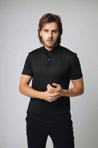 Model wearing the Dylan Polo by Yebo Clothing in a casual setting, promoting conscious fashion and minimalist loungewear. This polo combines carbon-neutral clothing standards with the benefits of moisture-wicking fabric for active lifestyles.
