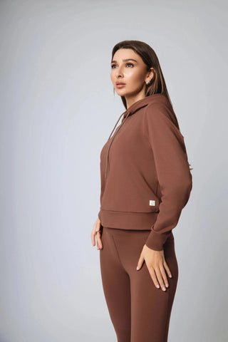 Harper Hoodie in action worn by a model, showcasing its breathable workout gear design crafted from ethical fitness apparel, made by Yebo Clothing with moisture-wicking fabric for ultimate comfort.