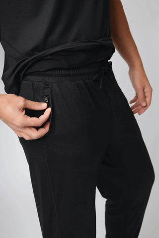 Back view of the Logan Jogger by Yebo Clothing, emphasizing its trendy look and features, including zippered pockets, part of a conscious fashion collection focused on carbon neutral clothing.