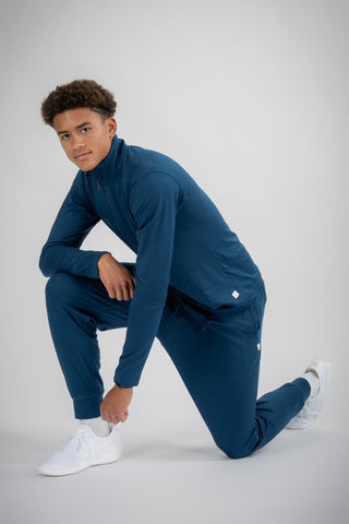 Model wearing the Lucas Quarter Zip from Yebo Clothing, demonstrating minimalist loungewear that combines style and comfort, made from recycled polyester for ethical fitness apparel.