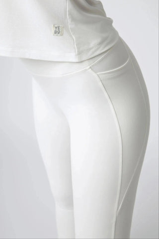 The Maha Legging by Yebo Clothing showcases buttery soft sculpting fabric designed for mindful movement, featuring smooth lines that accentuate the figure while being part of sustainable performance activewear made with recycled materials.