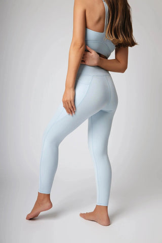 Model wearing the Maha Legging by Yebo Clothing, demonstrating the versatile design suitable for various activities, serving as minimalist loungewear or sustainable athleisure for gym-goers looking for performance hoodies and comfortable mens joggers.