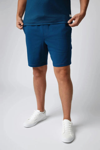 Close-up of Mason Shorts by Yebo Clothing, highlighting their minimalist loungewear style. Crafted with conscious fashion in mind, these shorts use recycled polyester to provide sustainable performance for your daily activities.
