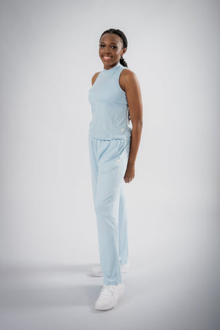 Model wearing Yebo Clothing's Sophie Tank Top in a sporty setting, demonstrating its stretchy and sculpted fit. This eco-friendly gym clothes choice is perfect for transitioning between brunch and a workout with confidence.