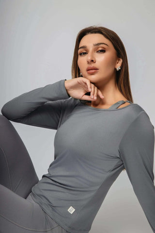 The Valentina Ballerina Shirt by Yebo Clothing elegantly drapes against a serene backdrop, embodying the essence of conscious fashion with its eco-friendly, recycled materials and moisture-wicking technology for all-day comfort.