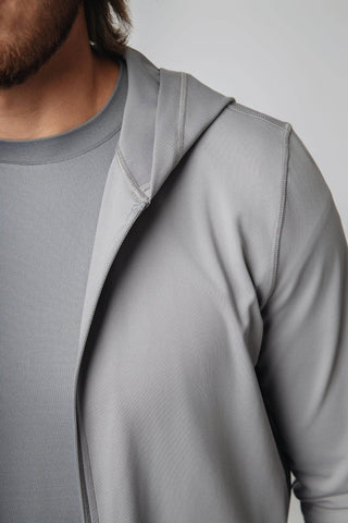 The Zahaan Hoodie by Yebo Clothing displayed on a hanger, representing eco-friendly gym clothes made from recycled polyester. This performance hoodie is part of the conscious fashion movement, ideal for staying cozy and stylish during workouts or lounging.